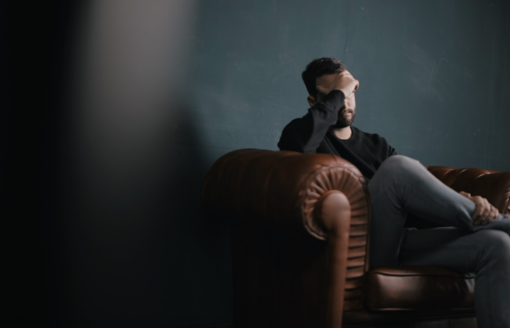 Man on couch disappointed Stop Erectile dysfunction in its tracks