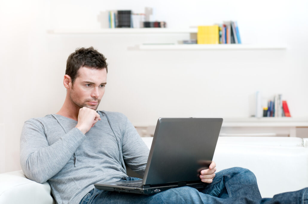 Man working on laptop at determining questions to ask his doctor about testosterone