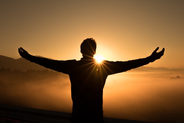  man looking at sunset on mountain, BPC-157 peptide therapy for health